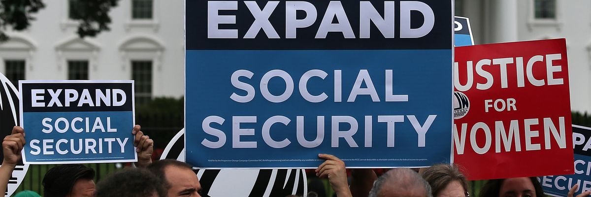 Activists participate in a rally urging the expansion of Social Security benefits in front of the White House July 13, 2015