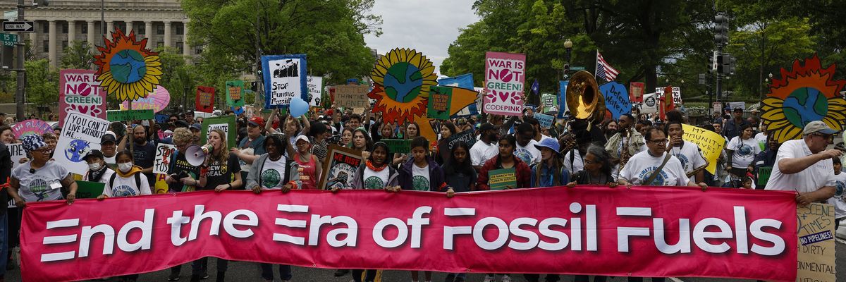 Activists participate in an Earth Day march titled “End the Era of Fossil Fuels."