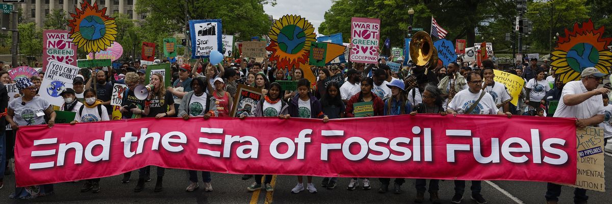 Activists participate in an Earth Day march titled “End the Era of Fossil Fuels."