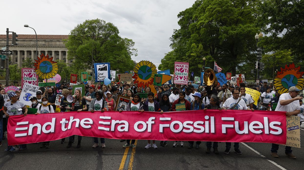 Activists participate in an Earth Day march titled “End the Era of Fossil Fuels."