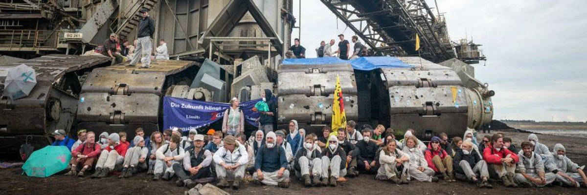 Activists place their bodies before a Bagger 288 coal digger