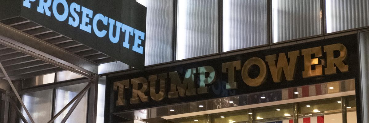 Activists project the world "Prosecute" onto Trump Tower