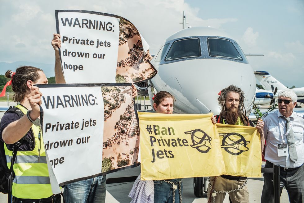 Activists protest the climate impacts of private jets during a protest at Geneva Airport.