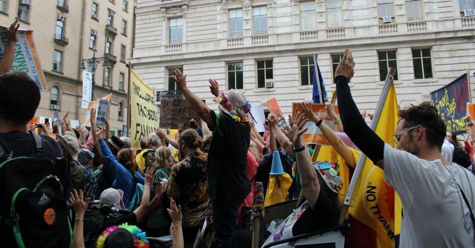 Activists raise their hands for a moment of silence, followed by waves of raucous cheers, during the People's Climate March on September 21, 2014. (Common Dreams: CC BY-SA 3.0 US)