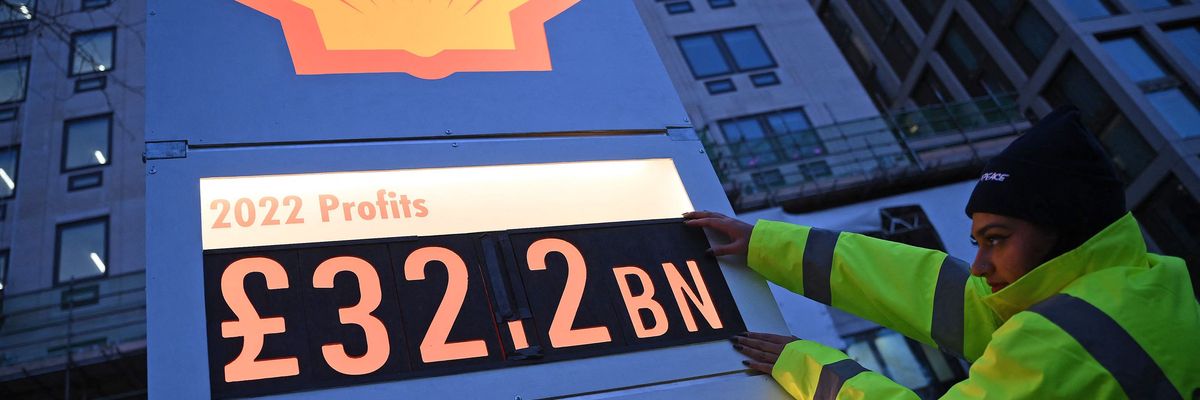 Activists set up a mock gas station price board