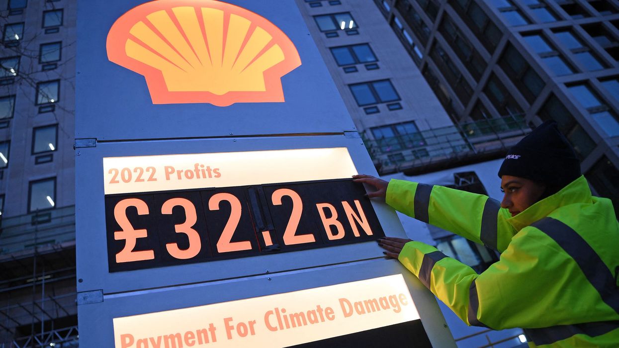 Activists set up a mock gas station price board