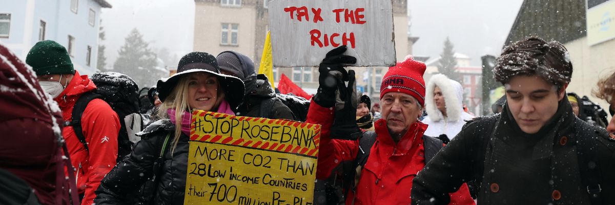 Activists take part in a protest ahead of the World Economic Forum in Davos