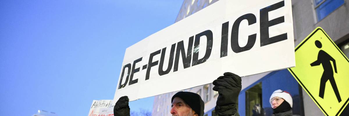 Activists take part in a vigil for Alex Pretti outside of the US Department of Veteran Affairs i
