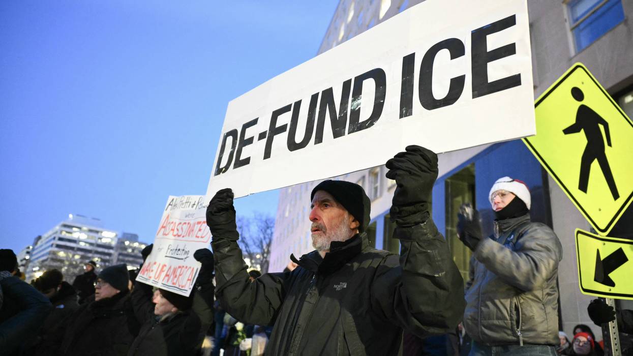 Activists take part in a vigil for Alex Pretti outside of the US Department of Veteran Affairs i