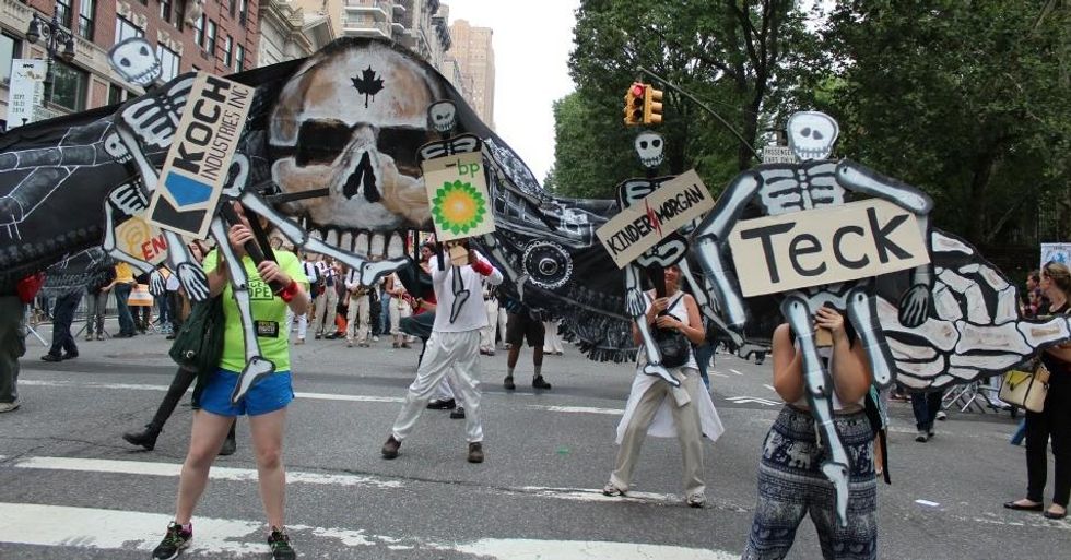 Activists use signs and puppets to protest big gas and oil companies at the People's Climate March on September 21, 2014. (Common Dreams: CC BY-SA 3.0 US)