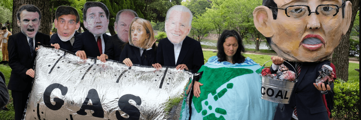 Activists with masks of Group of Seven leaders protest fossil fuels.