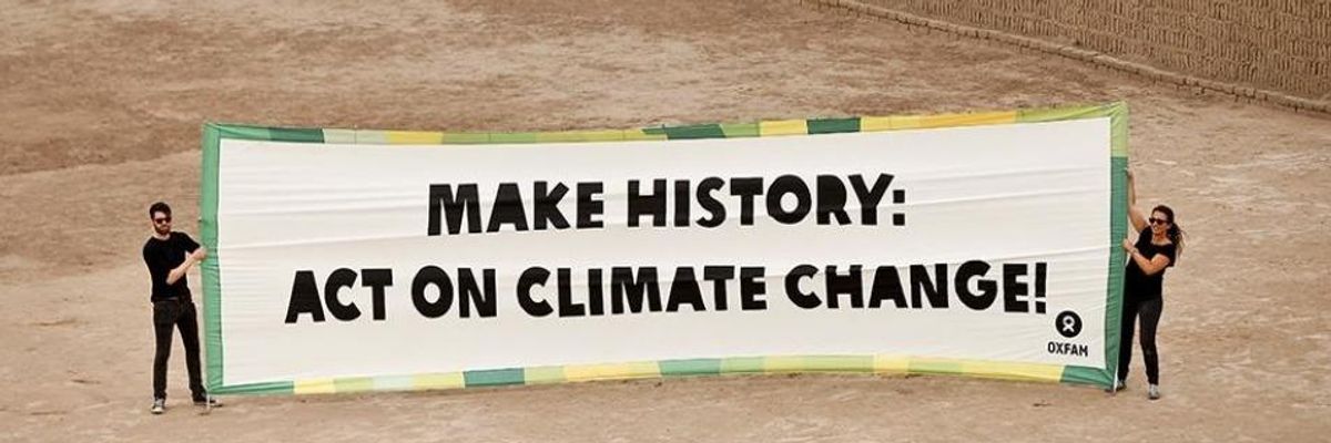 Activists with Oxfam International unveiled this banner at the Huaca Pucllana ruins in Lima, Peru on Sunday ahead of the climate talks that will begin on Monday.