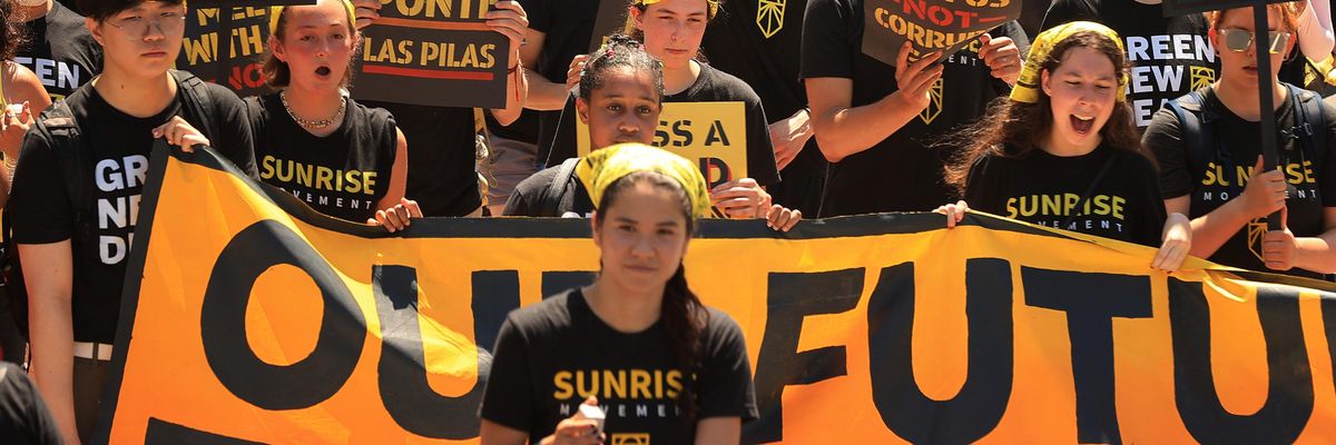 Activists with the Sunrise Movement march to the White House