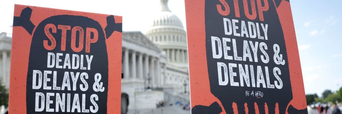 Advocates hold signs during a news conference on Medicare Advantage plans