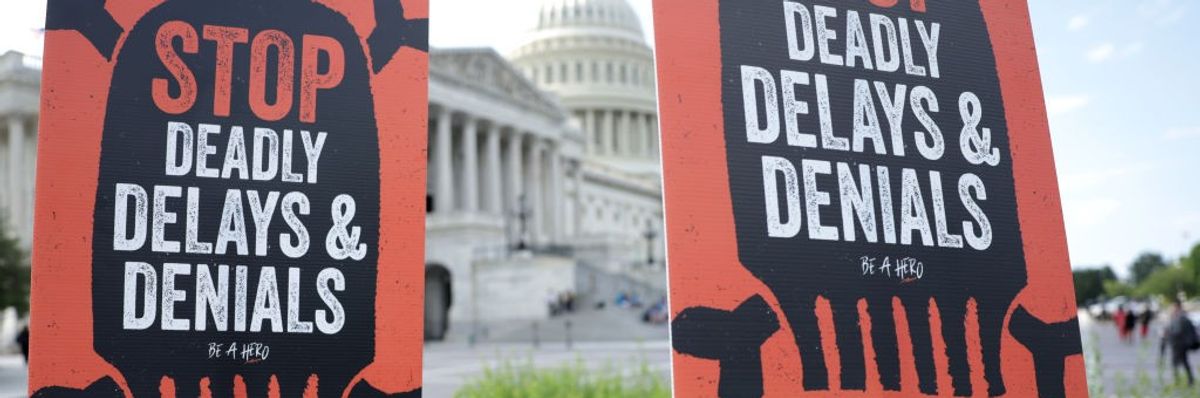 Advocates hold signs during a news conference on Medicare Advantage plans