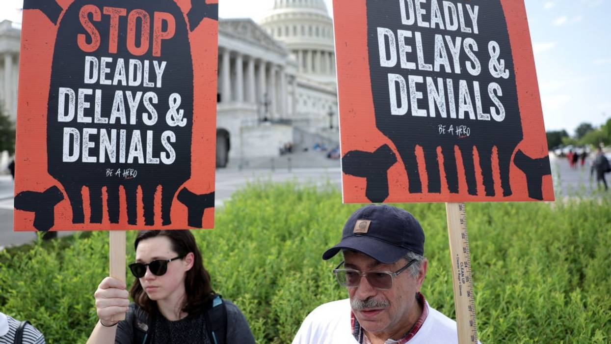 Advocates hold signs during a news conference on Medicare Advantage plans