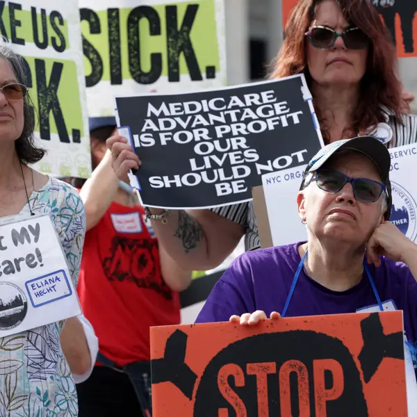 Advocates hold signs during a news conference on Medicare Advantage plans