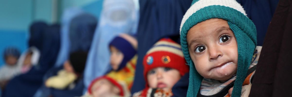 Afghan children are seen with their mothers in Kabul, Afghanistan on January 16, 2022.