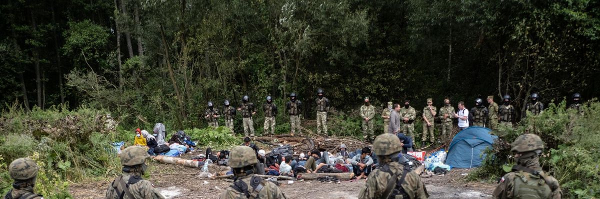 Afghan refugees are surrounded by security forces at the Poland-Belarus border on August 26, 2021. The group of migrants from Afghanistan has been stuck at the E.U.'s eastern border for several weeks as Belarus and Poland both refuse to let them in. (Photo: Maciej Moskwa/NurPhoto via Getty Images)