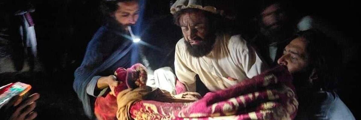 Afghans evacuate the wounded following an earthquake