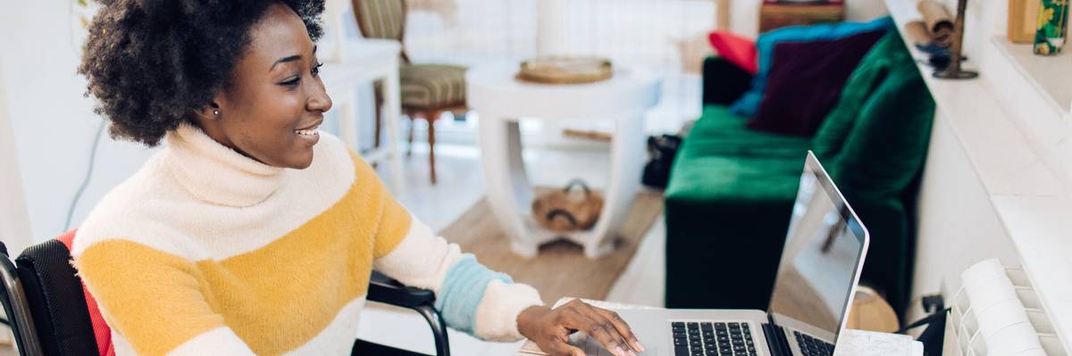 African American woman in a wheelchair working from home.