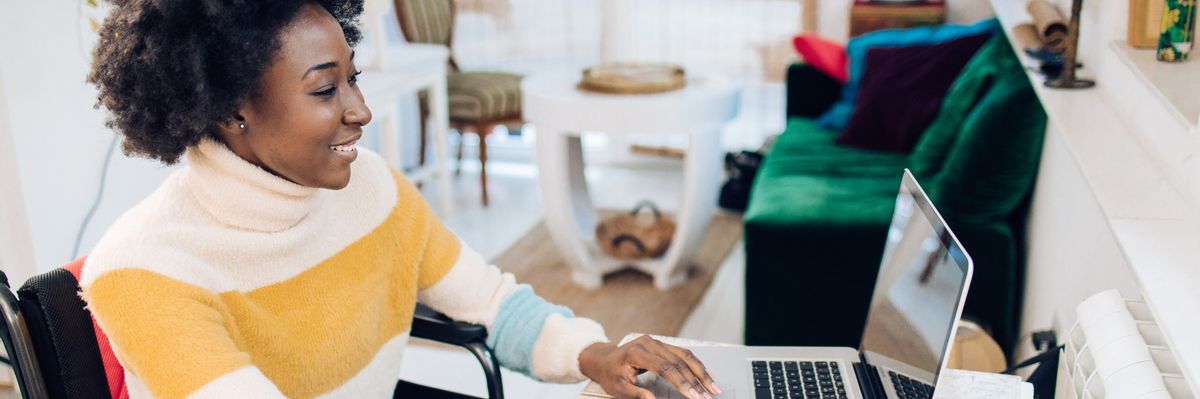 African American woman in a wheelchair working from home.