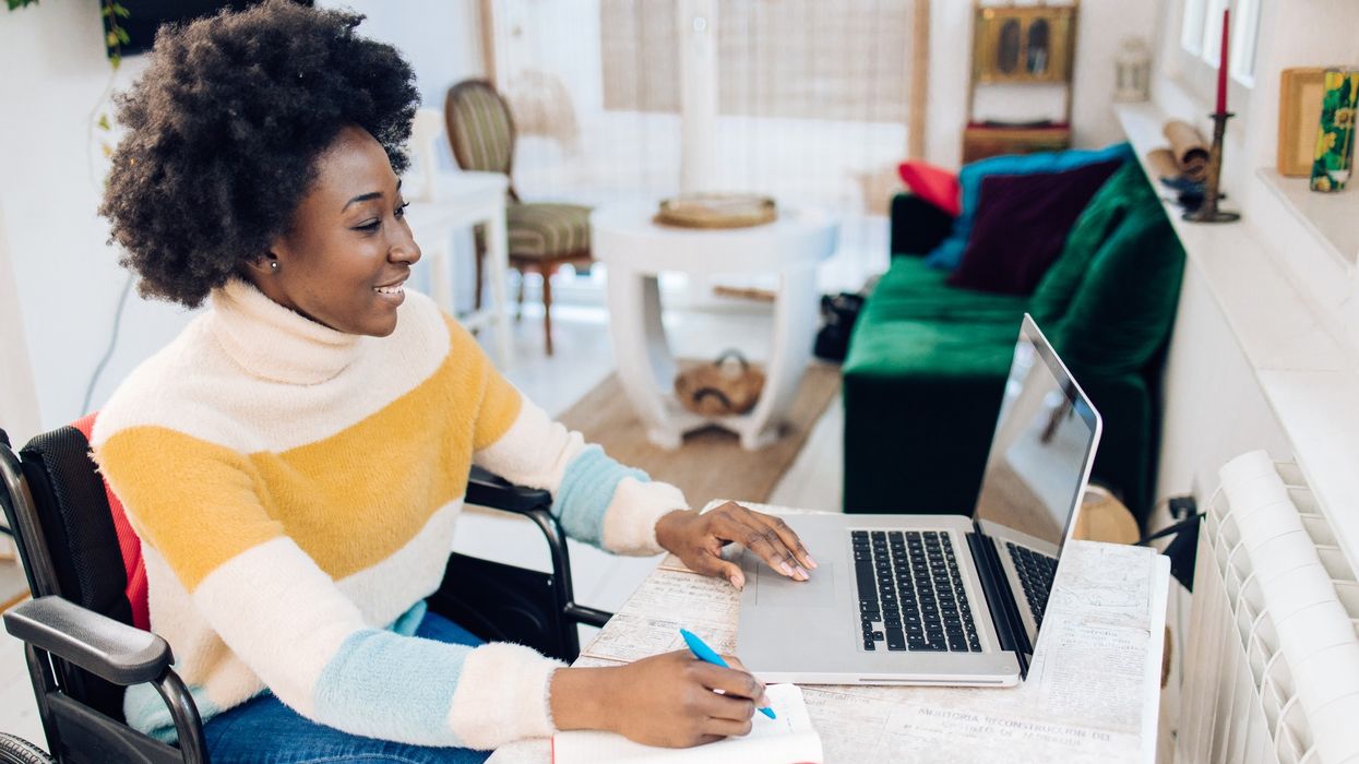African American woman in a wheelchair working from home.
