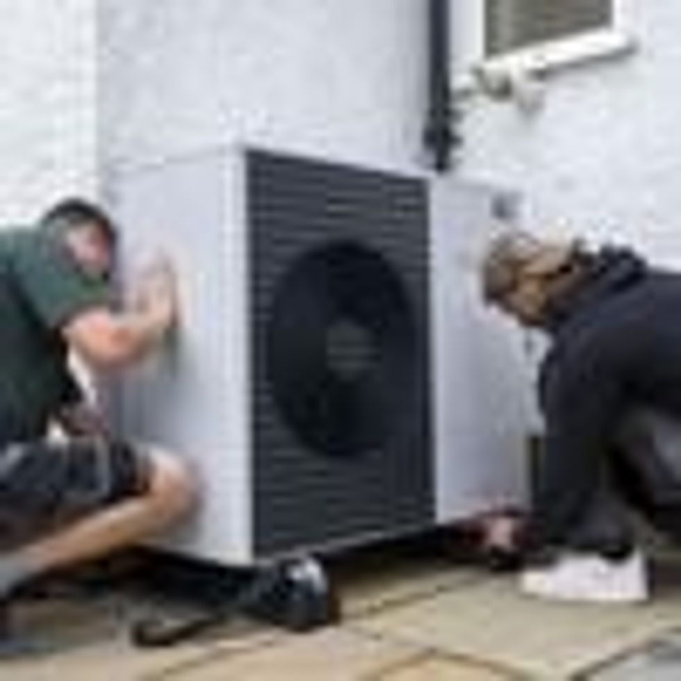 Air source heat pump installers from Solaris Energy installing a Vaillant Arotherm plus 7kw air source heat pump unit into a 1930s built house in Folkestone, United Kingdom on September 20, 2021.