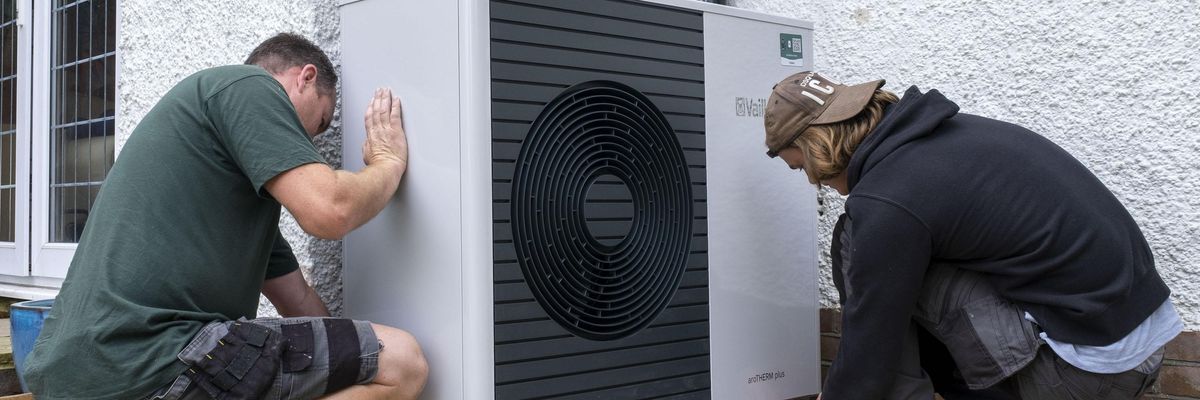 Air source heat pump installers from Solaris Energy installing a Vaillant Arotherm plus 7kw air source heat pump unit into a 1930s built house in Folkestone, United Kingdom on September 20, 2021.