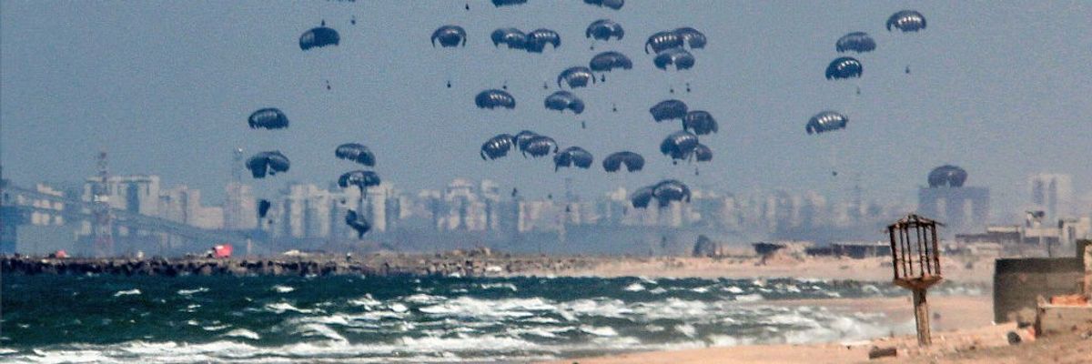 airdropped humanitarian aid parcels float down on parachutes to the beach in Gaza