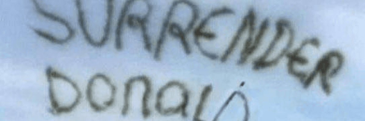 Airplane message in sky reads, "Surrender Donald"