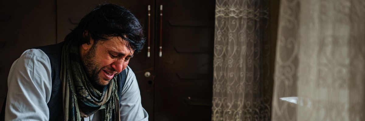 Ajmal Ahmadi weeps after members of his family were killed