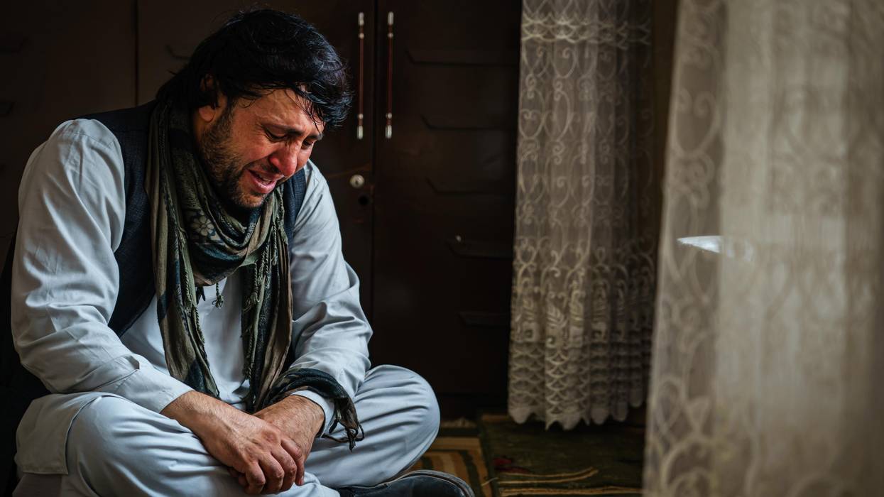 Ajmal Ahmadi weeps after members of his family were killed