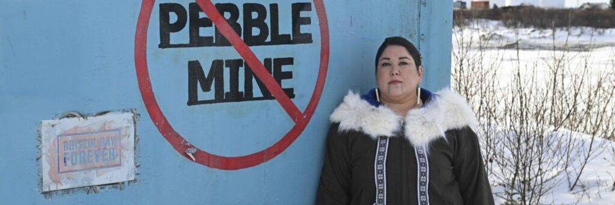 Alannah Acaq Hurley next to No Pebble Mine graffiti.