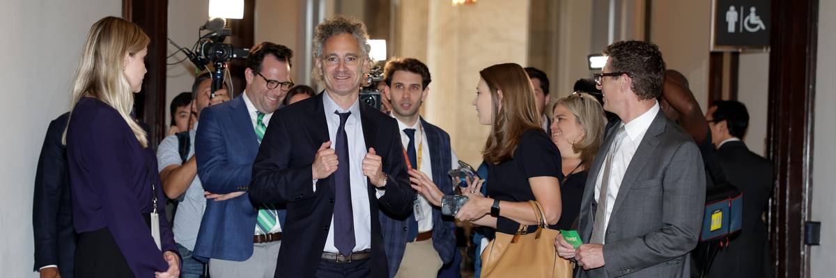 Alex Karp leaves Senate meeting.