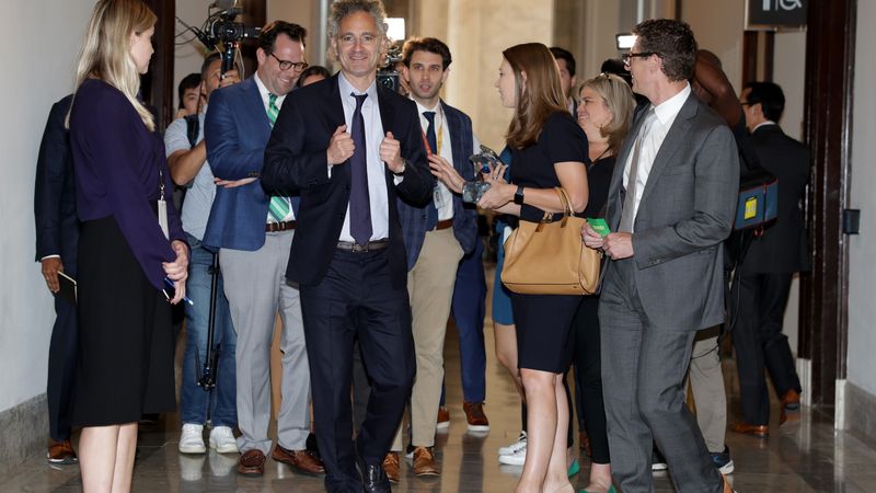 Alex Karp leaves Senate meeting.