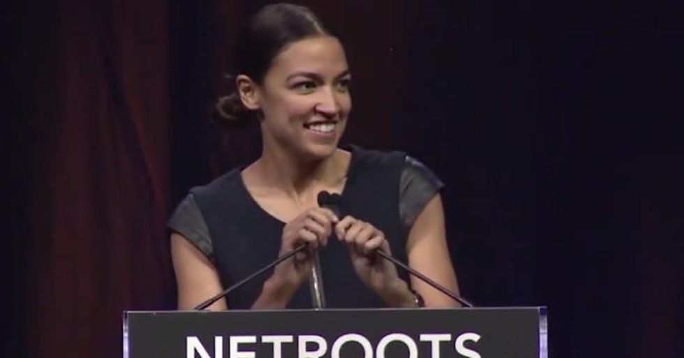 Alexandria Ocasio-Cortez takes the stage for the closing keynote at Netroots Nation 2018. (Screengrab)