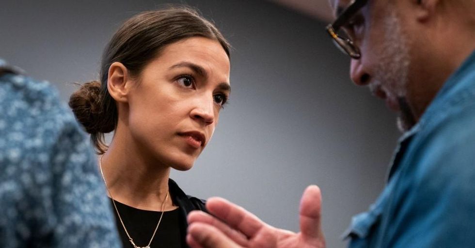 Alexandria Ocasio-Cortez talks with a voter at the conclusion of a town hall event, September 19, 2018 in The Bronx borough of New York City. (Photo: Drew Angerer/Getty Images)