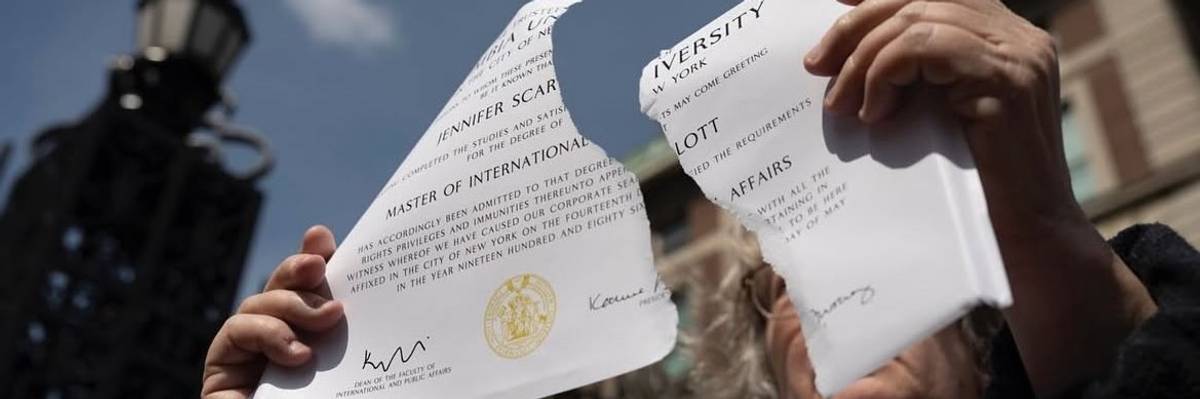 Alumna rips up SIPA diploma.
