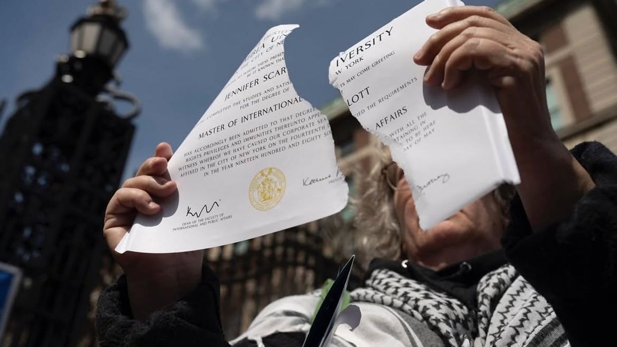 Alumna rips up SIPA diploma.