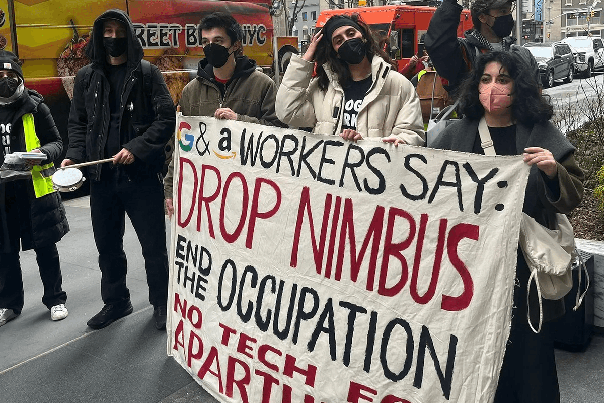 Amazon and Google workers hold a sign saying "Drop Project Nimbus"