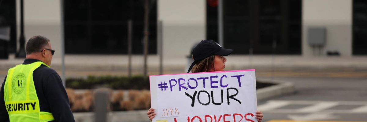 Amazon worker holds protest sign