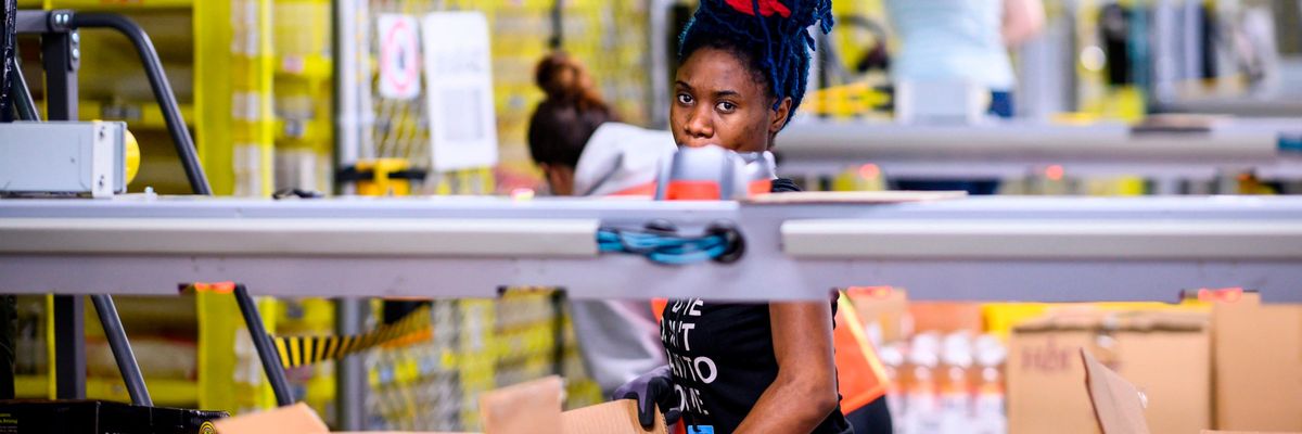 Amazon workers at a distribution station