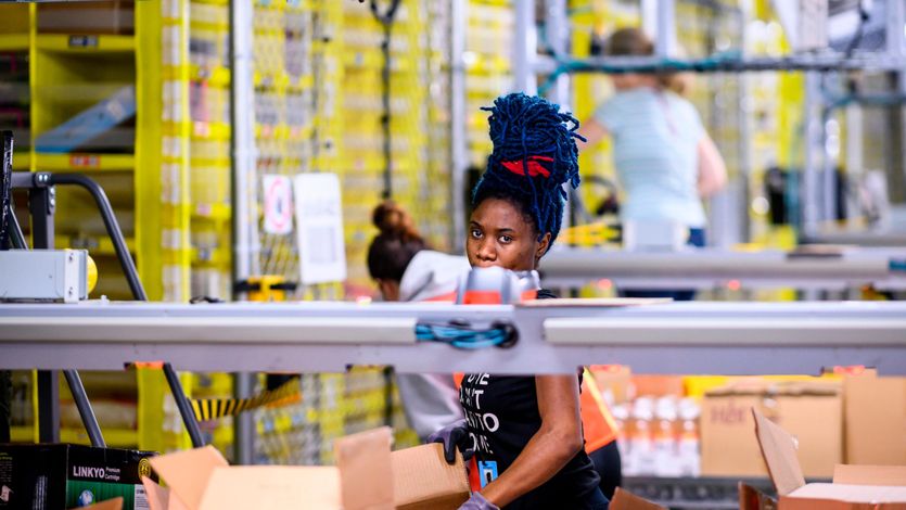 Amazon workers at a distribution station