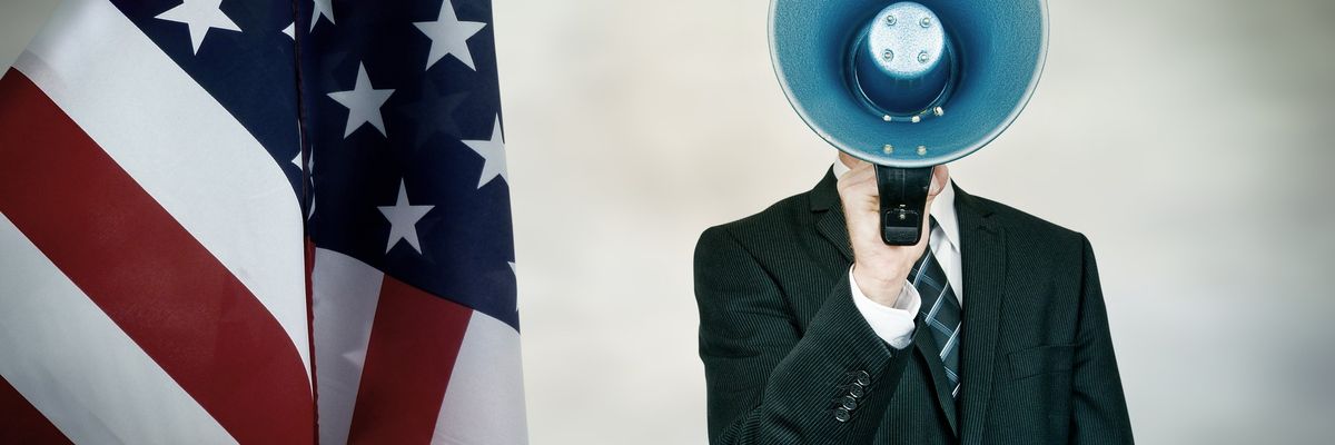 American flad and a person in a business suit yelling into microphone