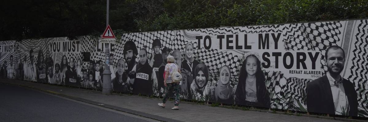 Amsterdam's Palestine Solidarity Action mural in tribute to those killed in Gaza. Alareer's is the first image on right.