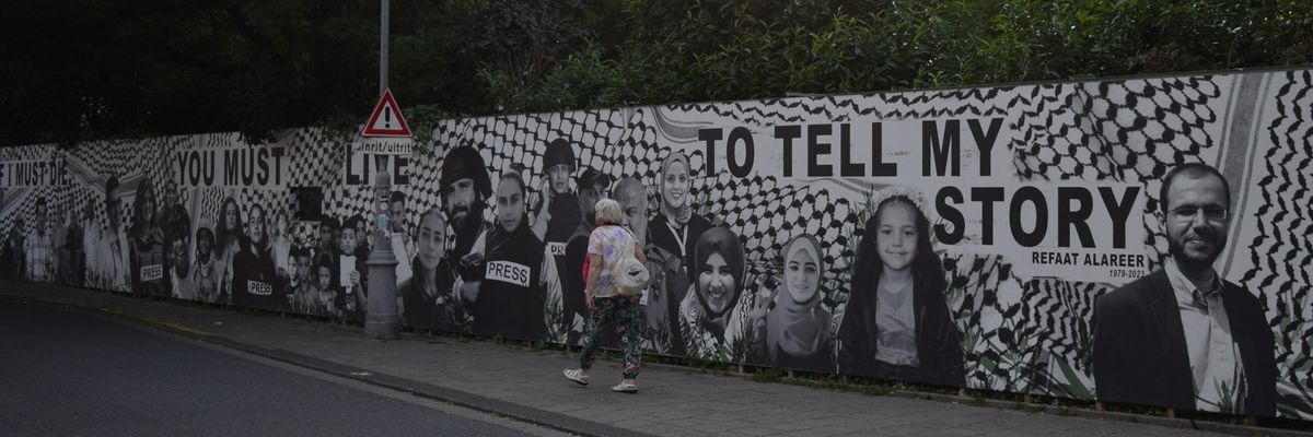 Amsterdam's Palestine Solidarity Action mural in tribute to those killed in Gaza. Alareer's is the first image on right.