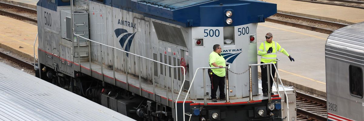 Amtrak workers service trains