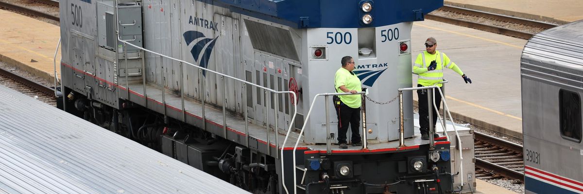 Amtrak workers service trains