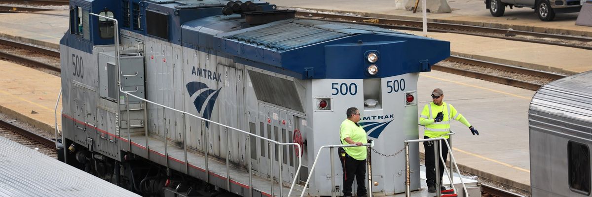 Amtrak workers service trains